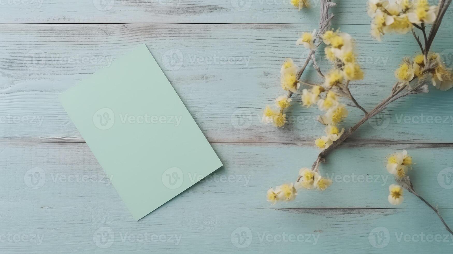Top View of Blank Invitation Card Paper Mockup and Blossom Branches on Wooden Table, . photo