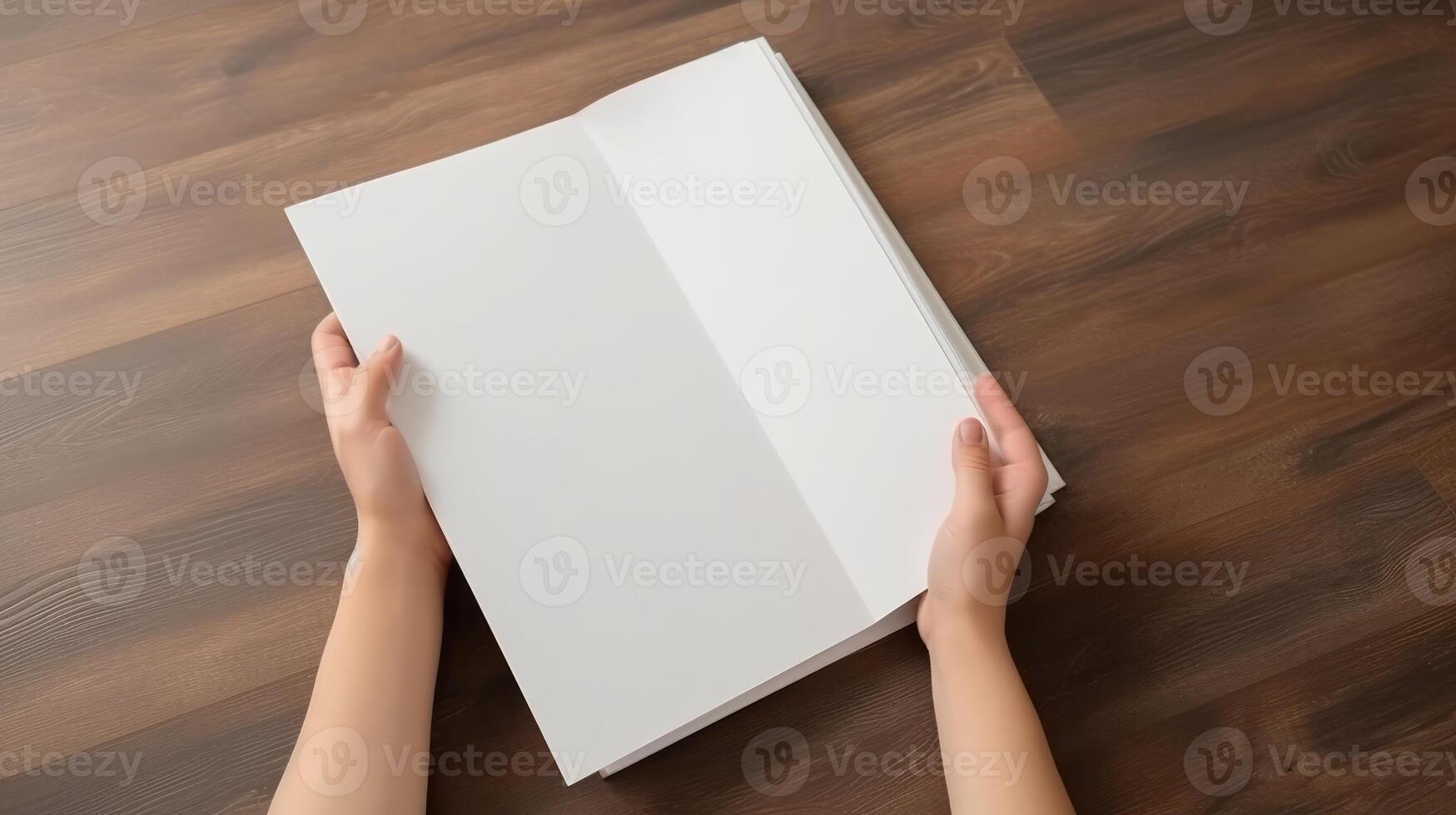 Top View Mockup of Human Hands Holding Blank White Paper Sheet, Flat Lay on Wooden Table. Technology. photo