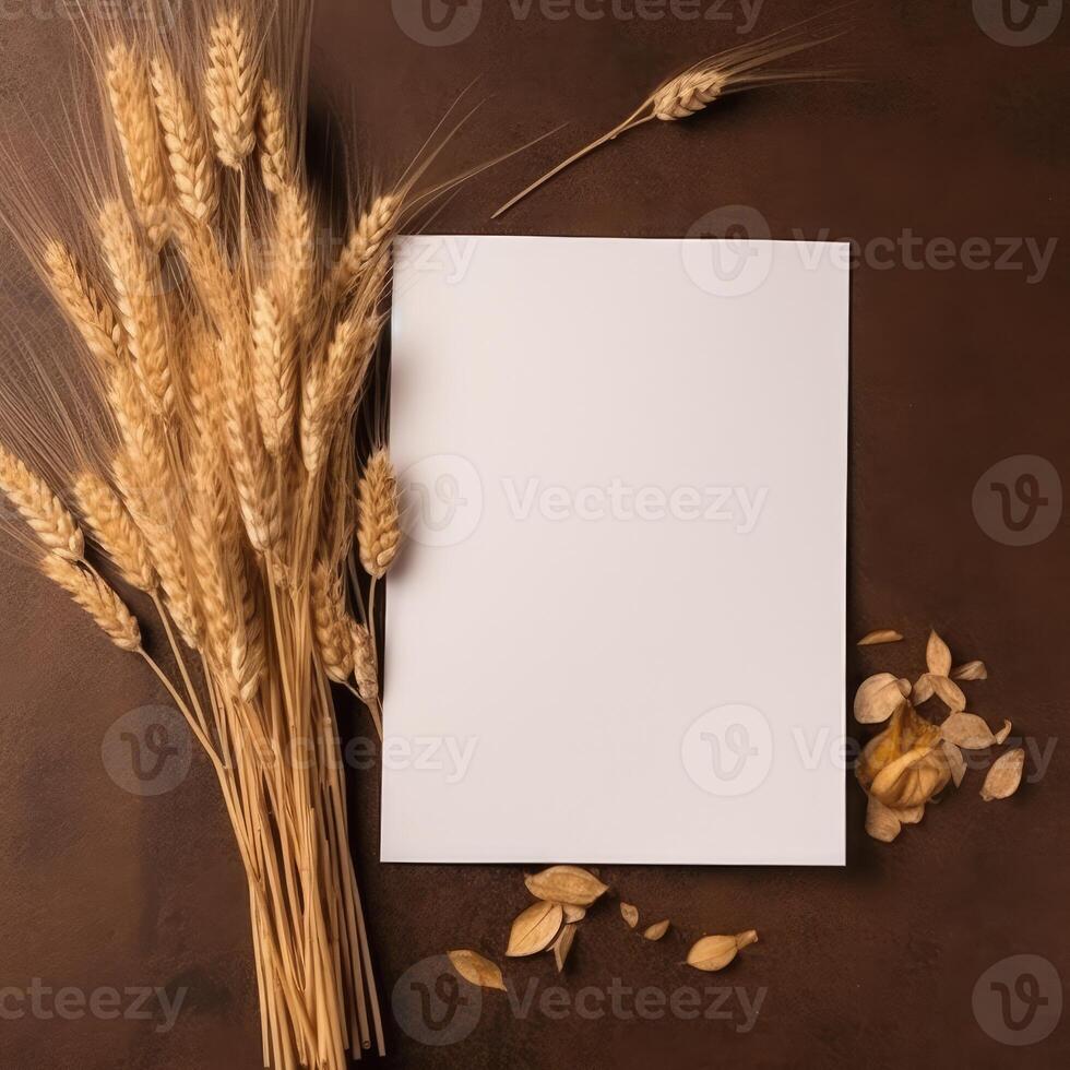 Top View of Blank White Paper with Golden Wheat Branch on Shiny Brown Background. Vintage Delicate Business or Wedding Card Design. . photo