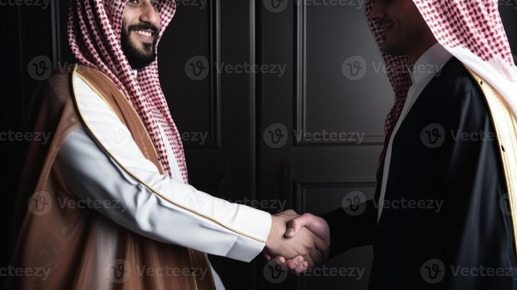 Cropped Image of Business Handshake Between Two Arabic Men in Their Traditional Attire. . photo