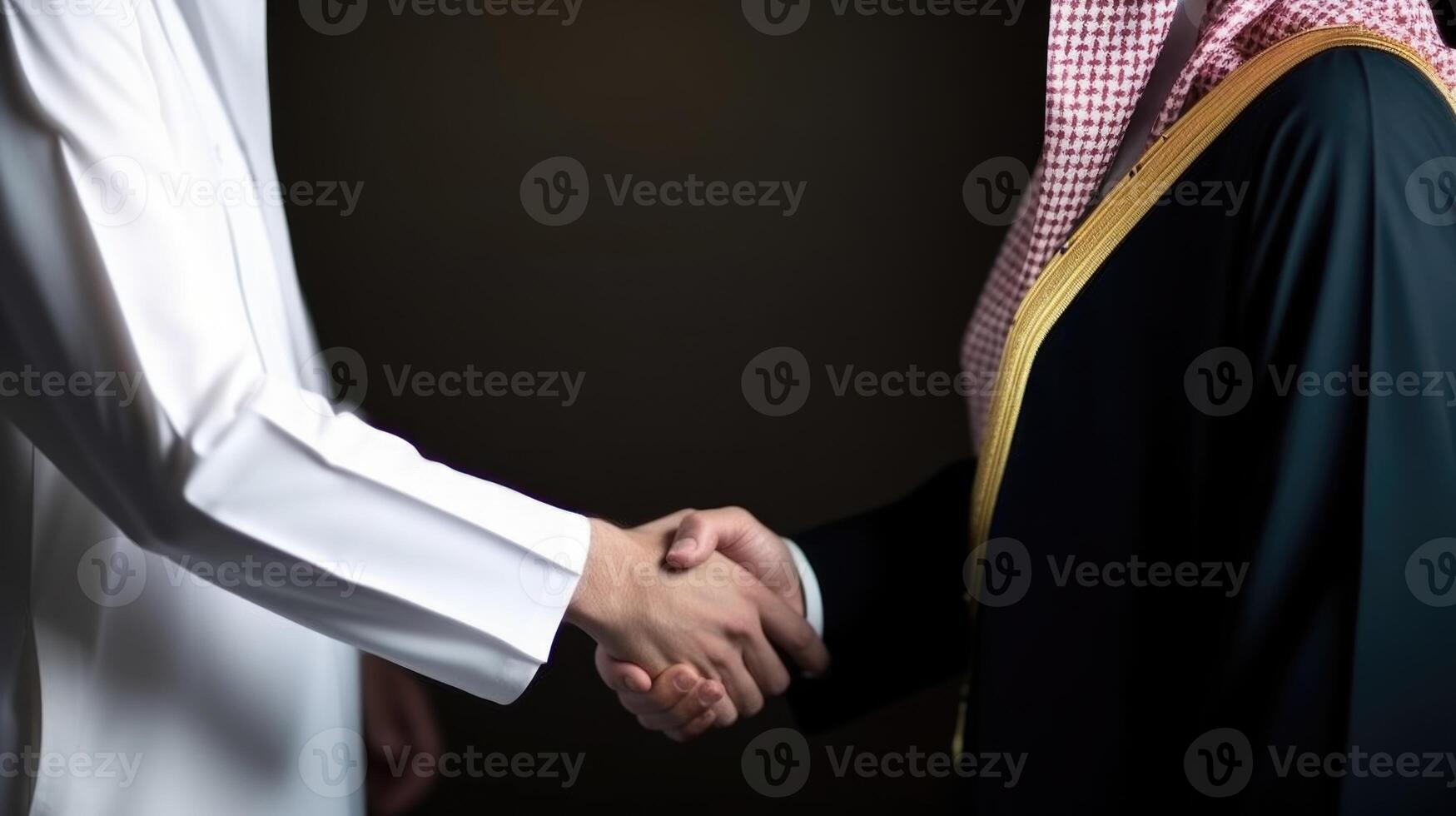 Cropped Image of Business Handshake Between Two Arabic Men in Their Traditional Attire. . photo