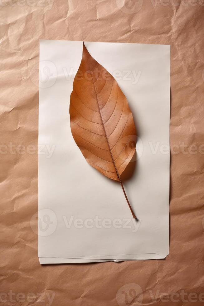 Top View of Blank White Paper Sheet Mockup and Brown Leaf on Crumpled Kraft Paper Background. . photo