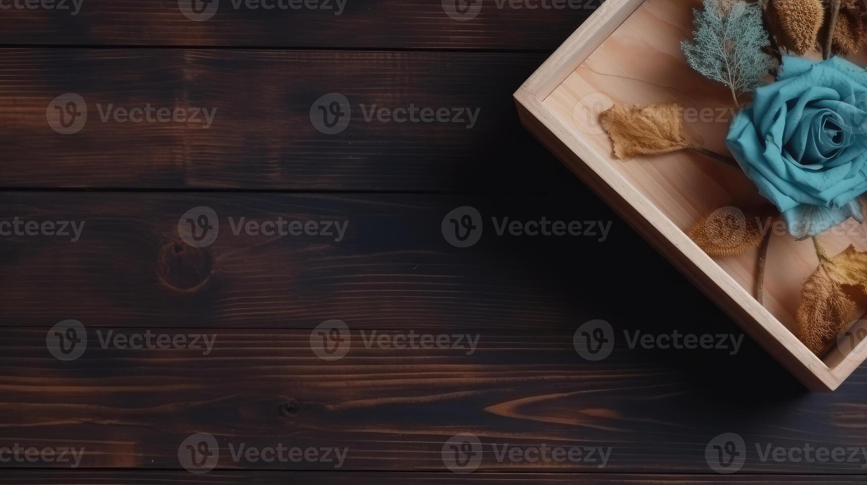 Closeup Vintage Wooden Box Full of Blue Rose and Dried Leaves on Plank Texture Table Top. . photo