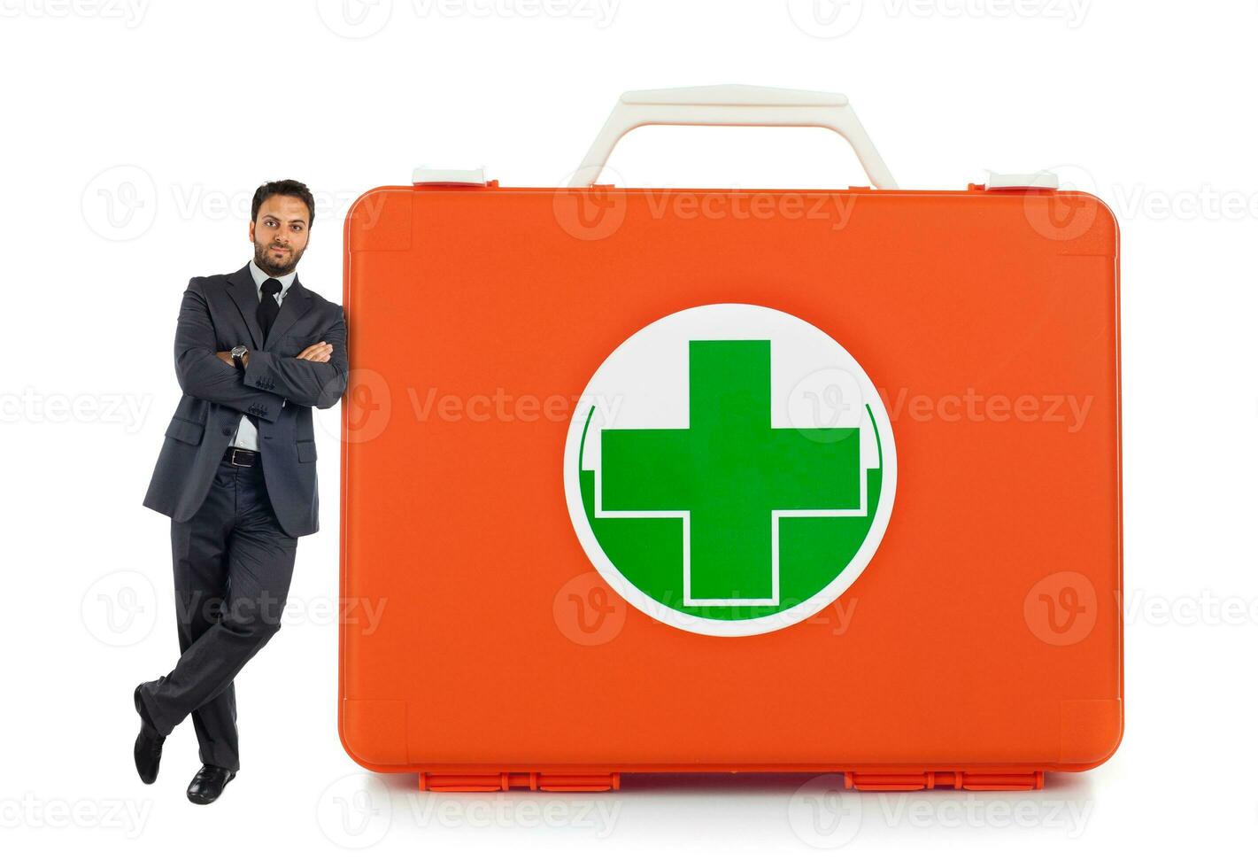 Young business man leaning against near the first aid box photo