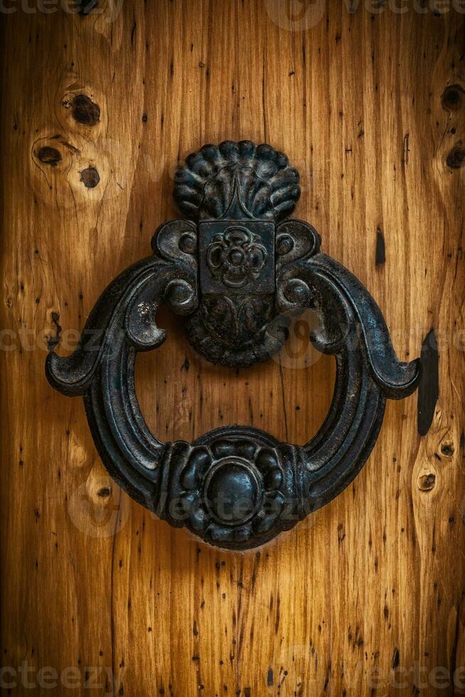 Antique handle of a solid wood door. photo