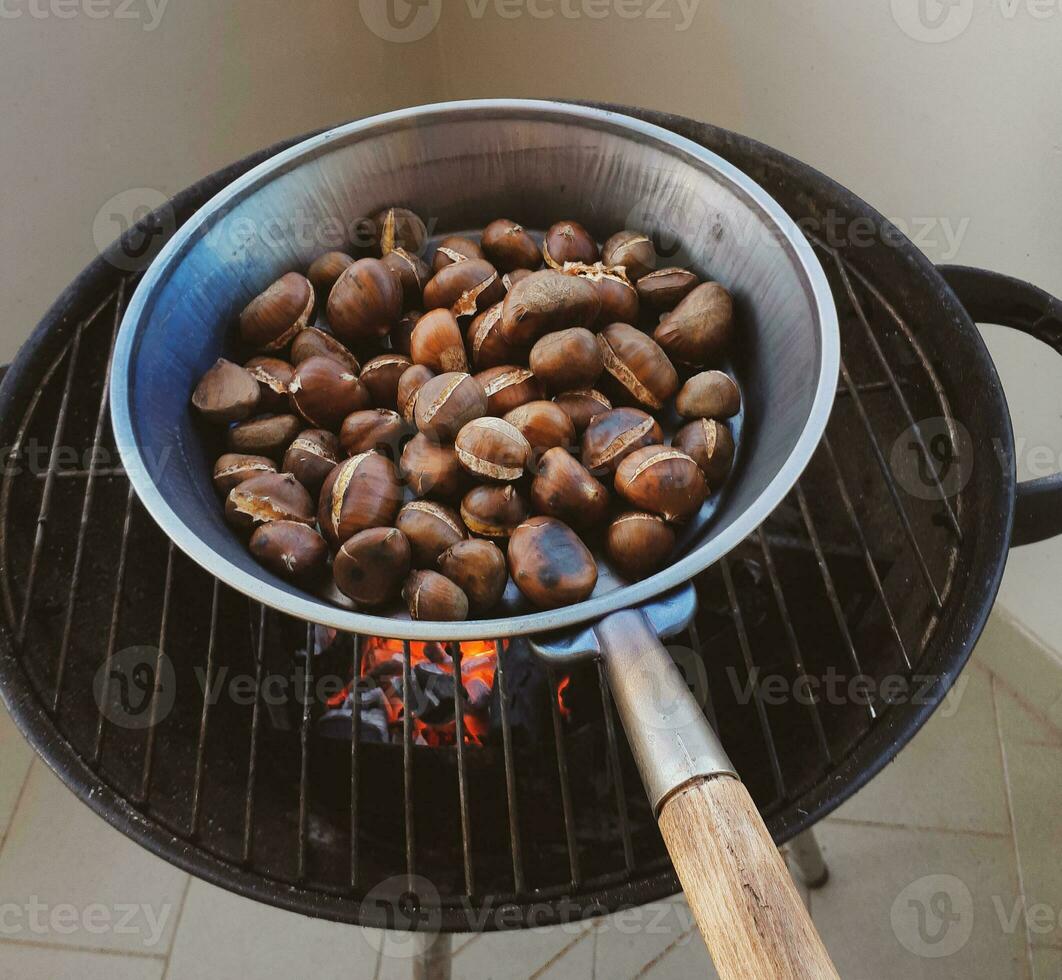 Roasted chestnuts in an iron pan photo
