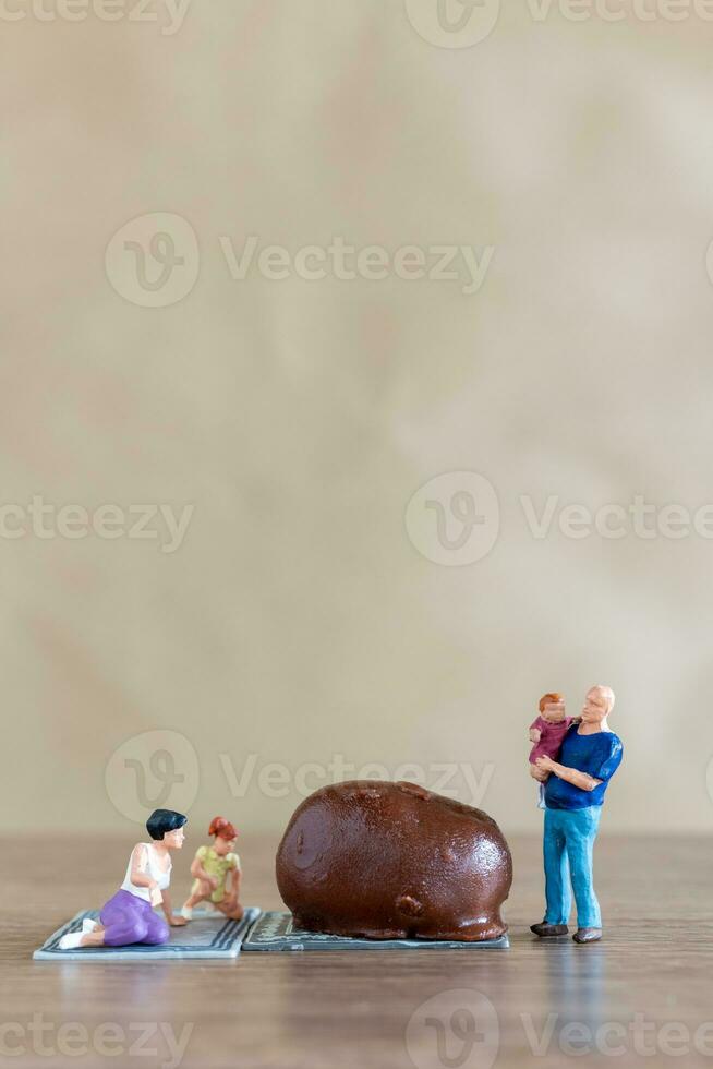 Miniature people Happy family enjoying chocolate photo