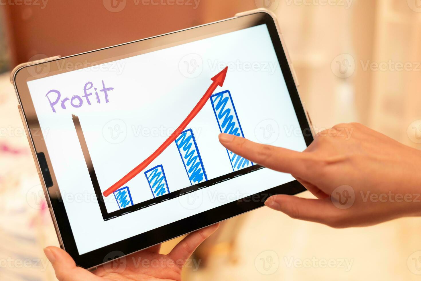 Using tablet to see business growth predication graph with blur background of department store. Business successful concept. Concept of growth planning and strategy. photo
