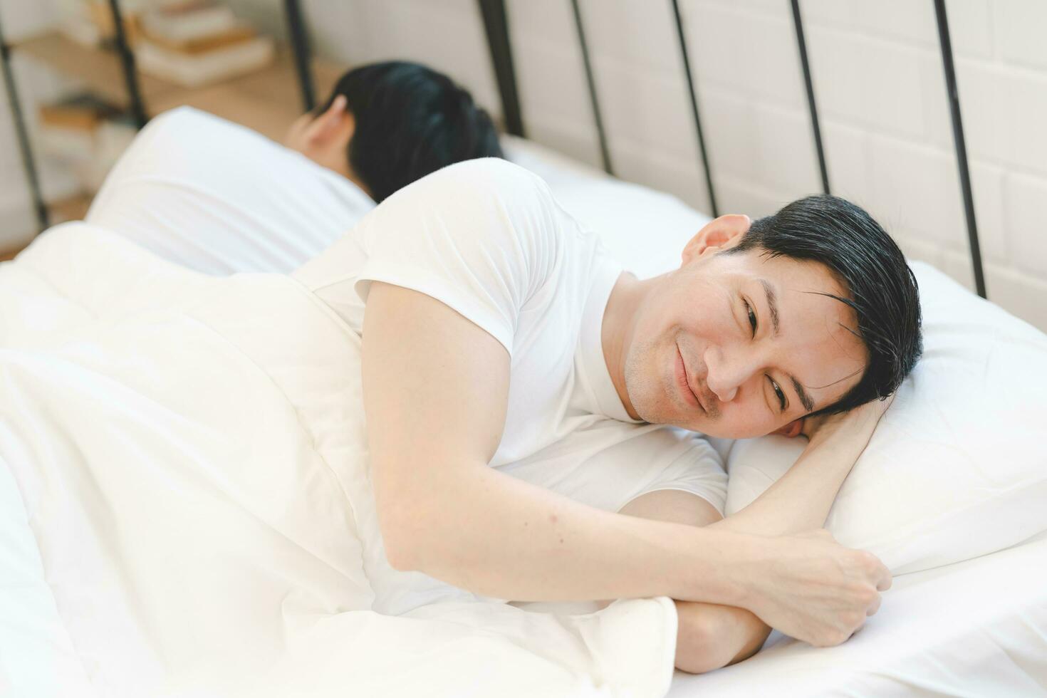 man lying on bed sleeping photo