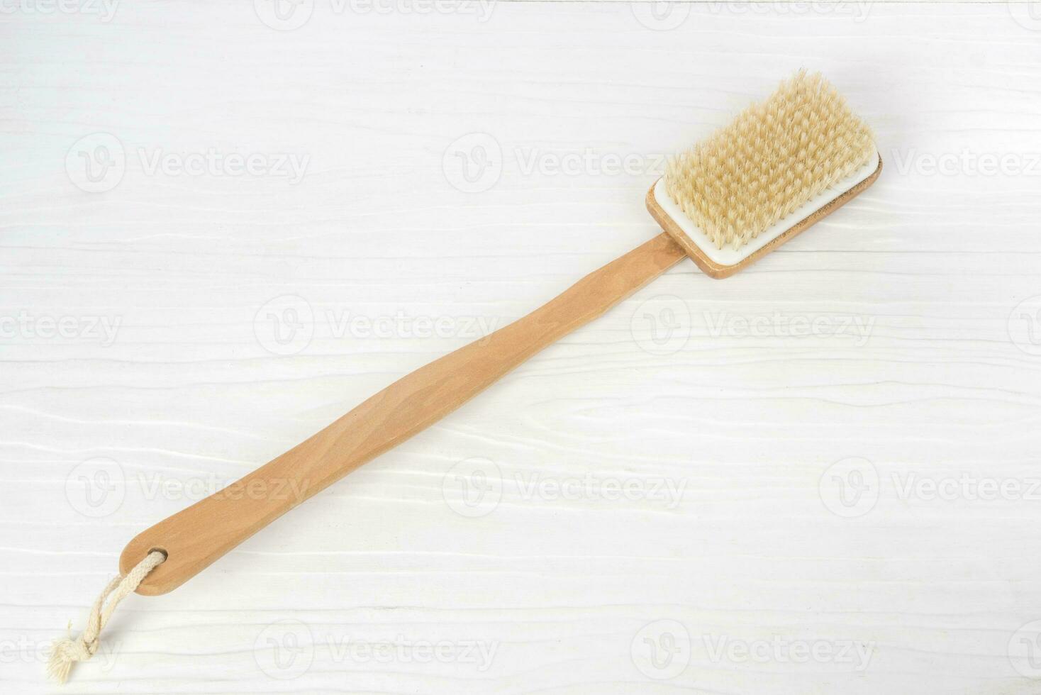 Bath brush on white wooden background photo