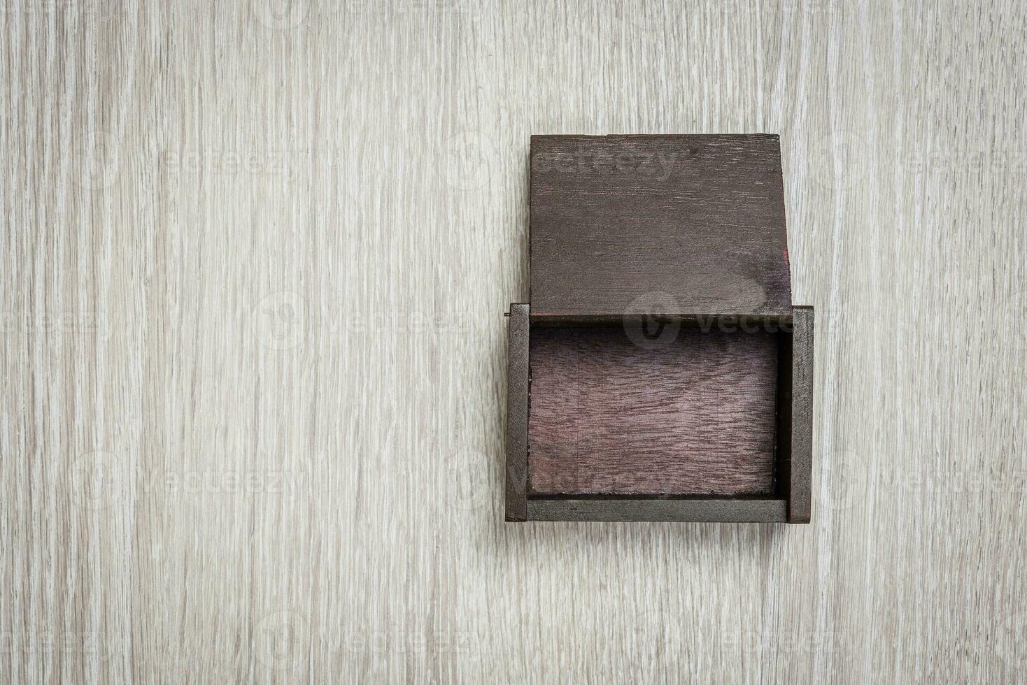 Dark brown wood box on wooden background photo