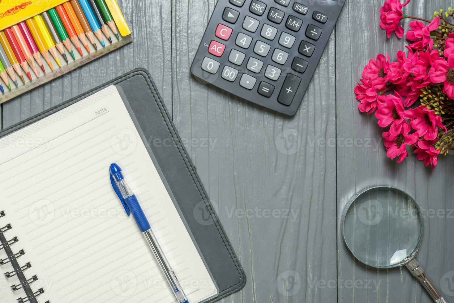 Notebook, pen, color pencil, Magnifier calculator  and tablet pc, on wood table background. Business concept. photo