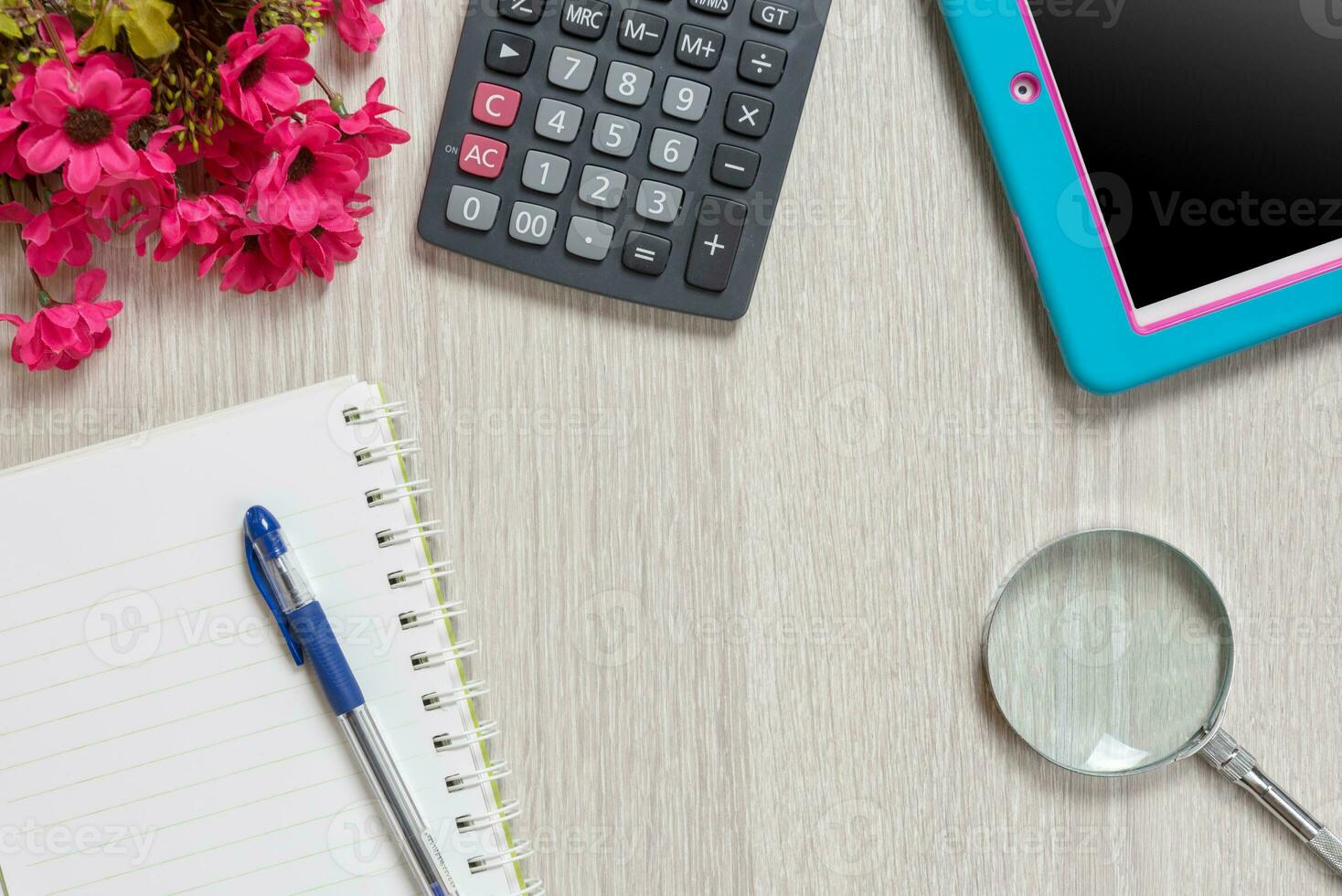 Notebook, pen, Magnifier, calculator and tablet pc, on wood table background. Business concept.. photo