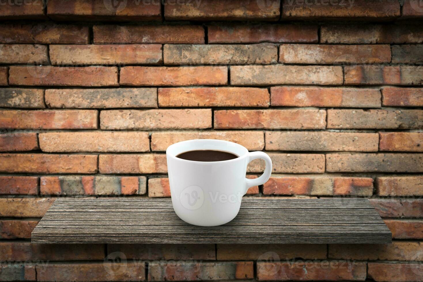 Coffee cup on the wooden over stone wall background photo