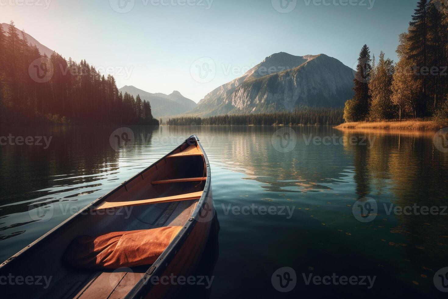 Canoe floating on a serene mountain lake surrounded by tall pine trees on a peaceful morning. photo