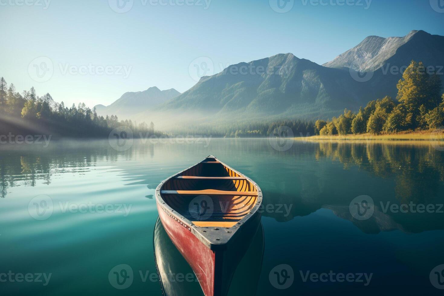 Canoe floating on a serene mountain lake surrounded by tall pine trees on a peaceful morning. photo