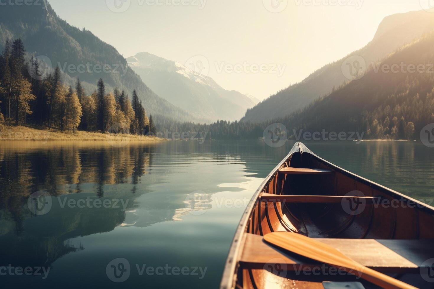 Canoe floating on a serene mountain lake surrounded by tall pine trees on a peaceful morning. photo