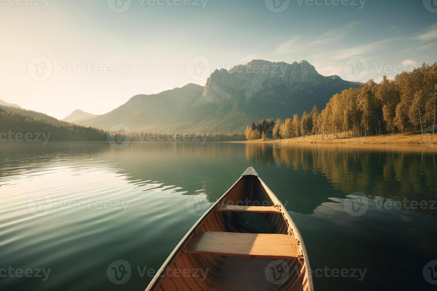 Canoe floating on a serene mountain lake surrounded by tall pine trees on a peaceful morning. photo