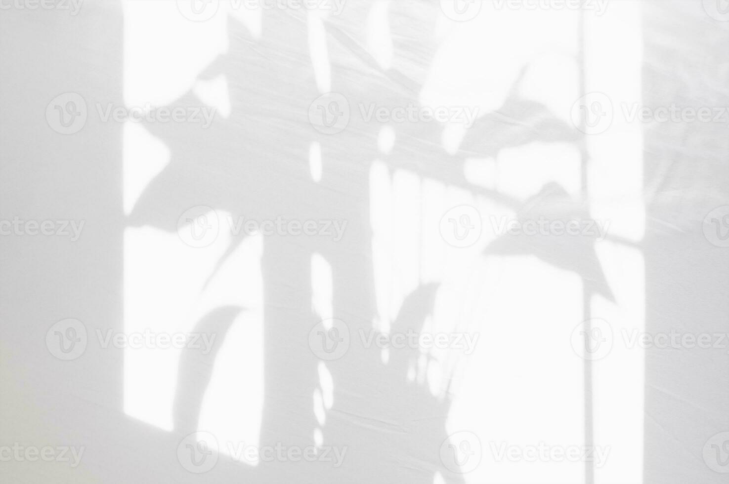 Shadow leaves overlay on white cotton bed sheet,Natural sunlight shining through window on abstract white fabric texture background. Cloth soft wave bedding on cozy bed photo