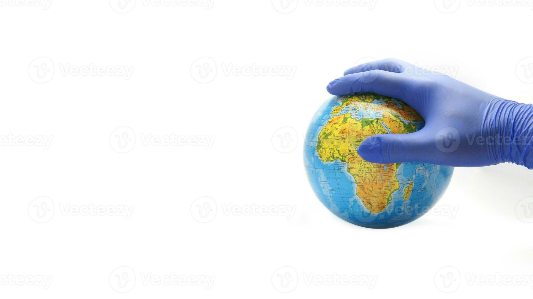 Globe covered by palm in blue protective glove. Safe World Travel. Stay Healthy photo