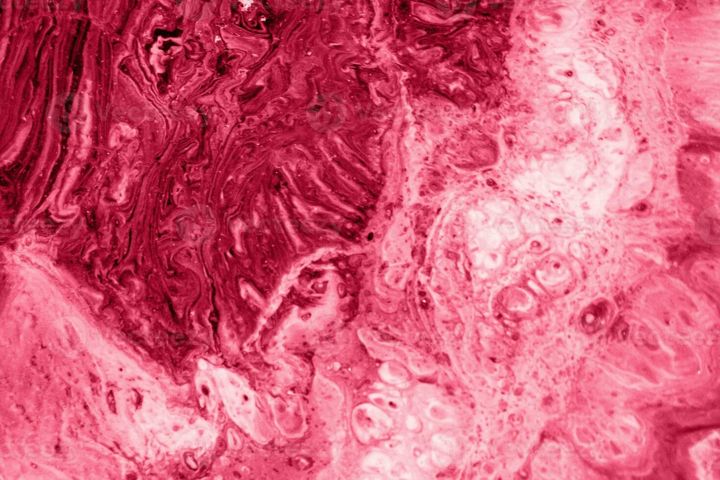Spread-out acrylic paint. Abstract background, made in the technique of fluid art. Demonstrating the colors of 2023 - Viva Magenta photo