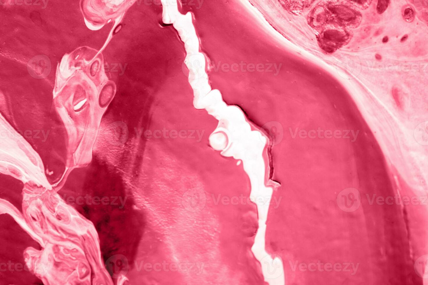 Spread-out acrylic paint. Abstract background, made in the technique of fluid art. Demonstrating the colors of 2023 - Viva Magenta photo