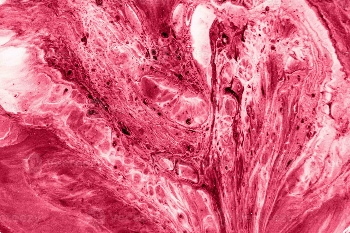 Spread-out acrylic paint. Abstract background, made in the technique of fluid art. Demonstrating the colors of 2023 - Viva Magenta photo