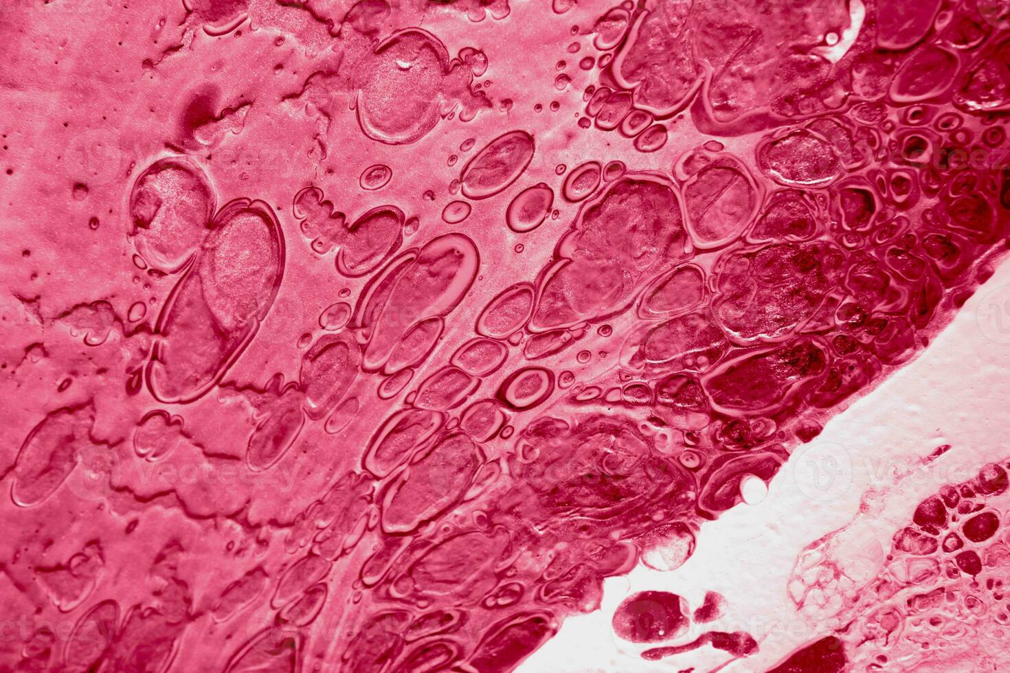 Spread-out acrylic paint. Abstract background, made in the technique of fluid art. Demonstrating the colors of 2023 - Viva Magenta photo
