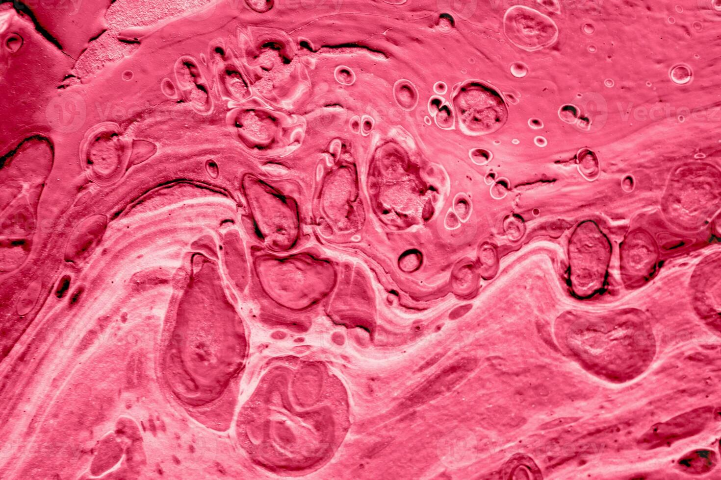 Spread-out acrylic paint. Abstract background, made in the technique of fluid art. Demonstrating the colors of 2023 - Viva Magenta photo