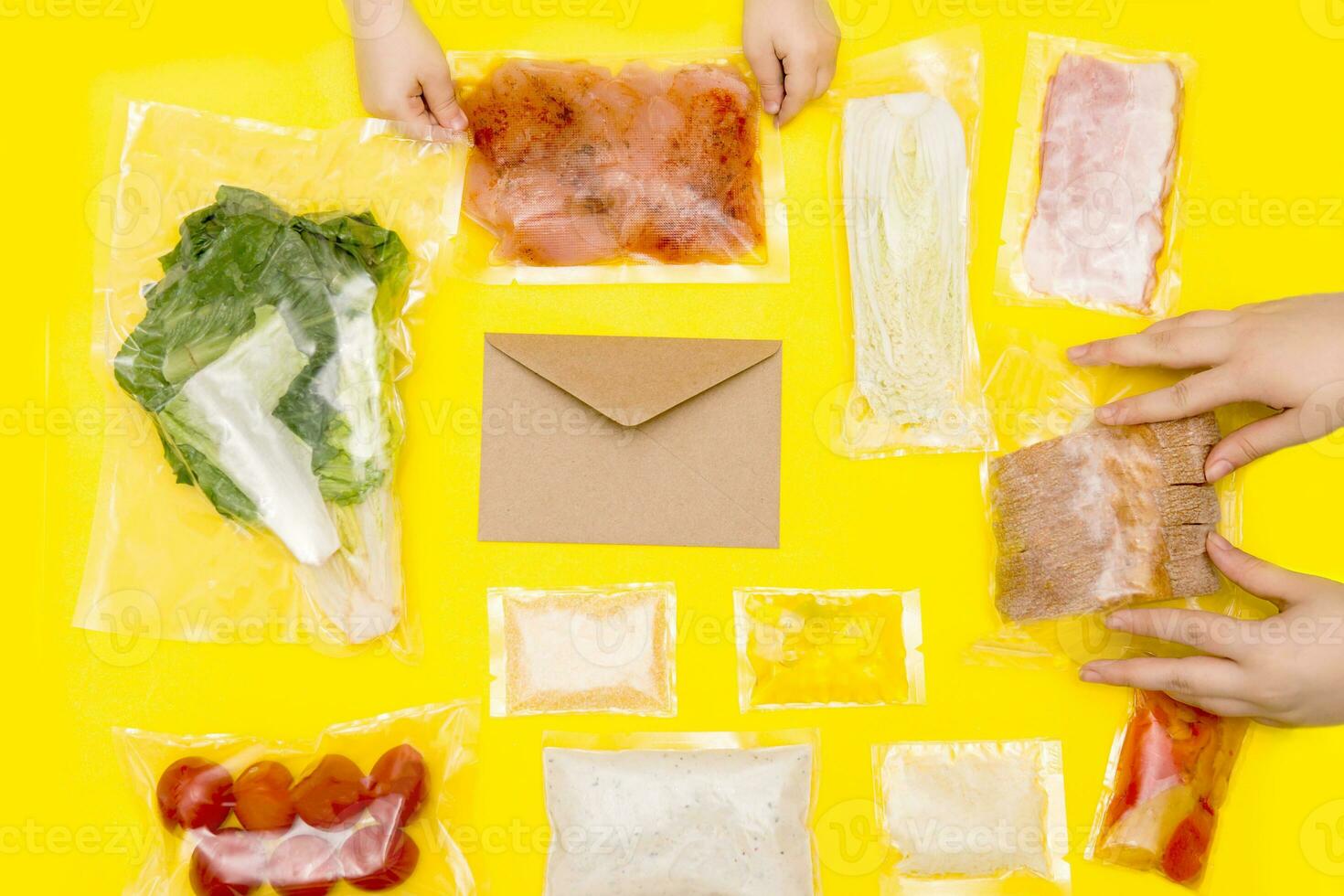 Hands holding bags of food. A set for delivering food for dinner on a yellow background. photo