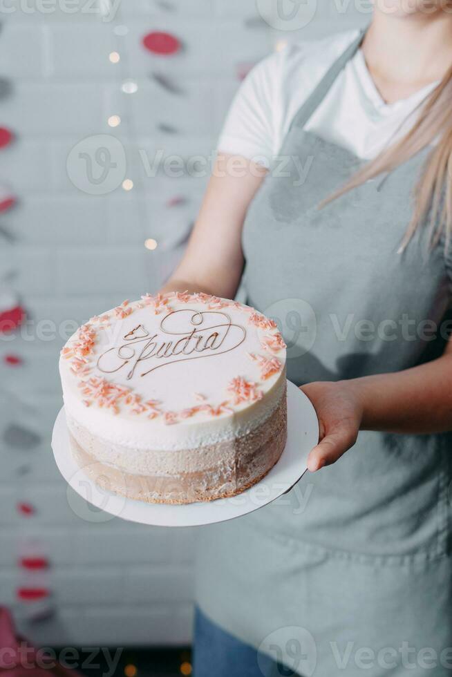 A beautiful mousse cake in the hands of a pastry chef photo