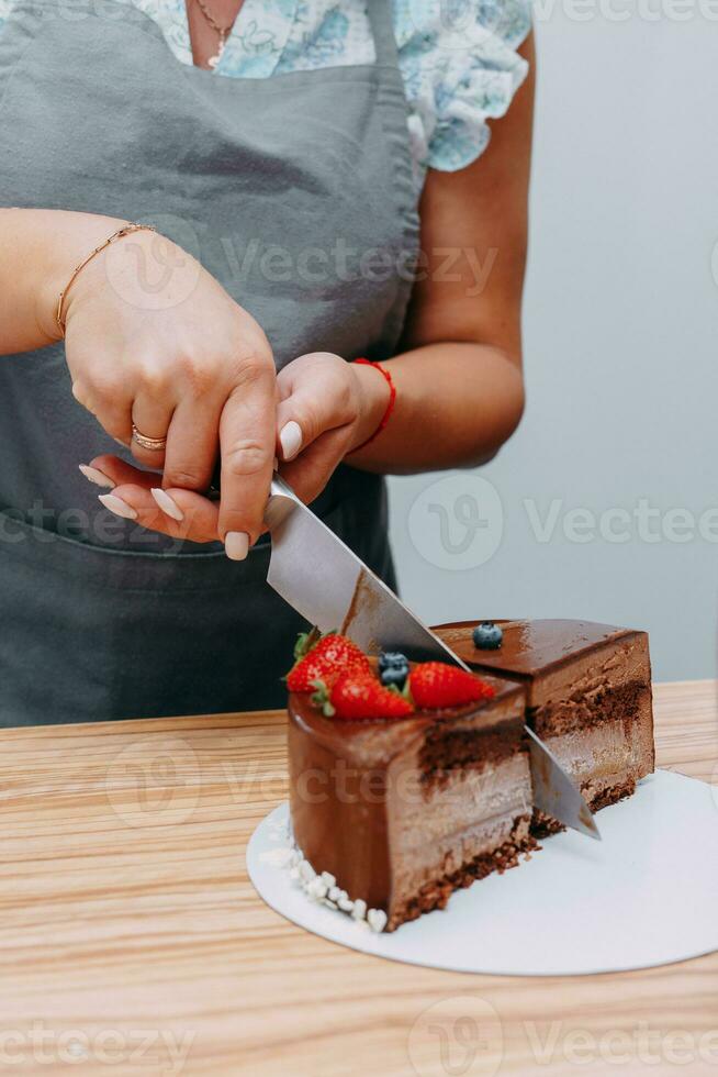 A piece of chocolate cake in the cut. Preparation of mousse cake at a culinary master class. Cooking at home, homemade food photo