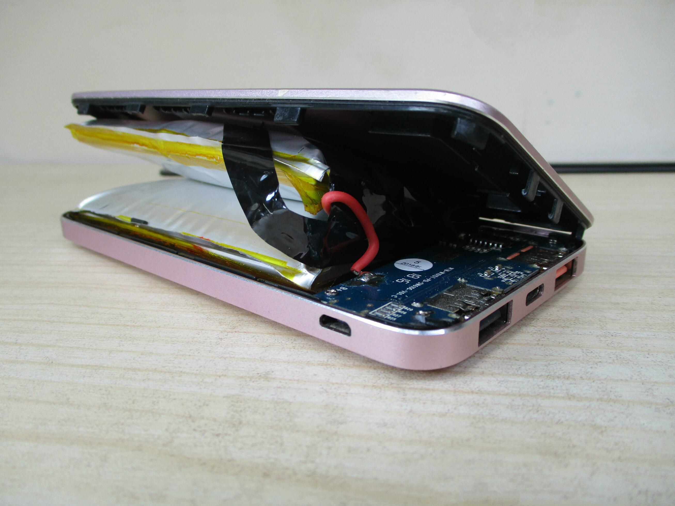 Lithium ion battery on powerbank, which has expanded. Broken battery