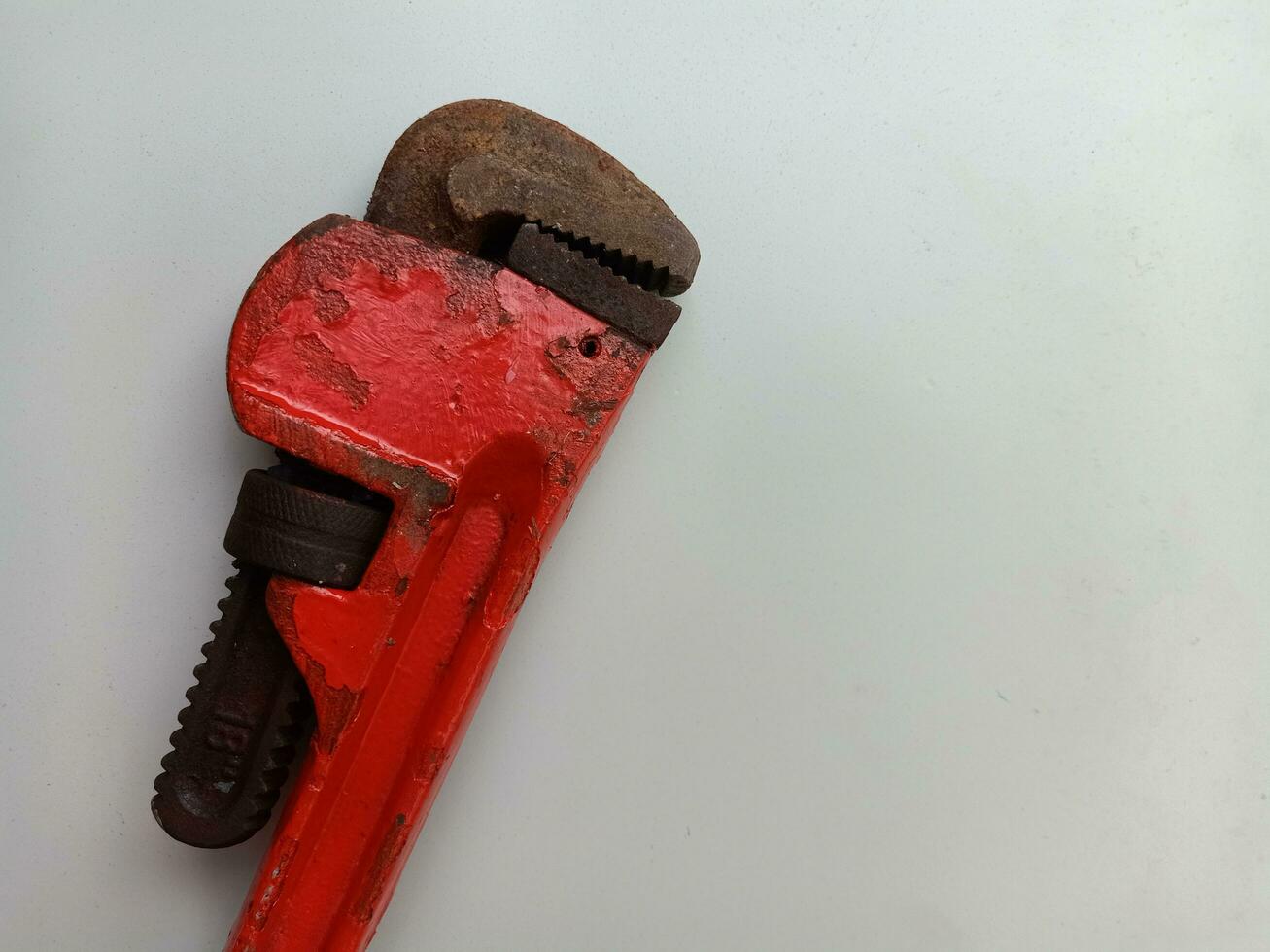 Rusty pipe wrench isolated on white background, photo concept for plumbing tools and equipment