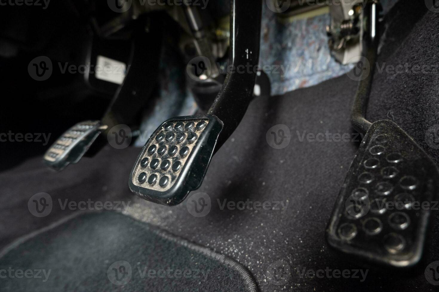 selectively focus on the gas pedal of a manual transmission type car. soft focus. under exposure photo