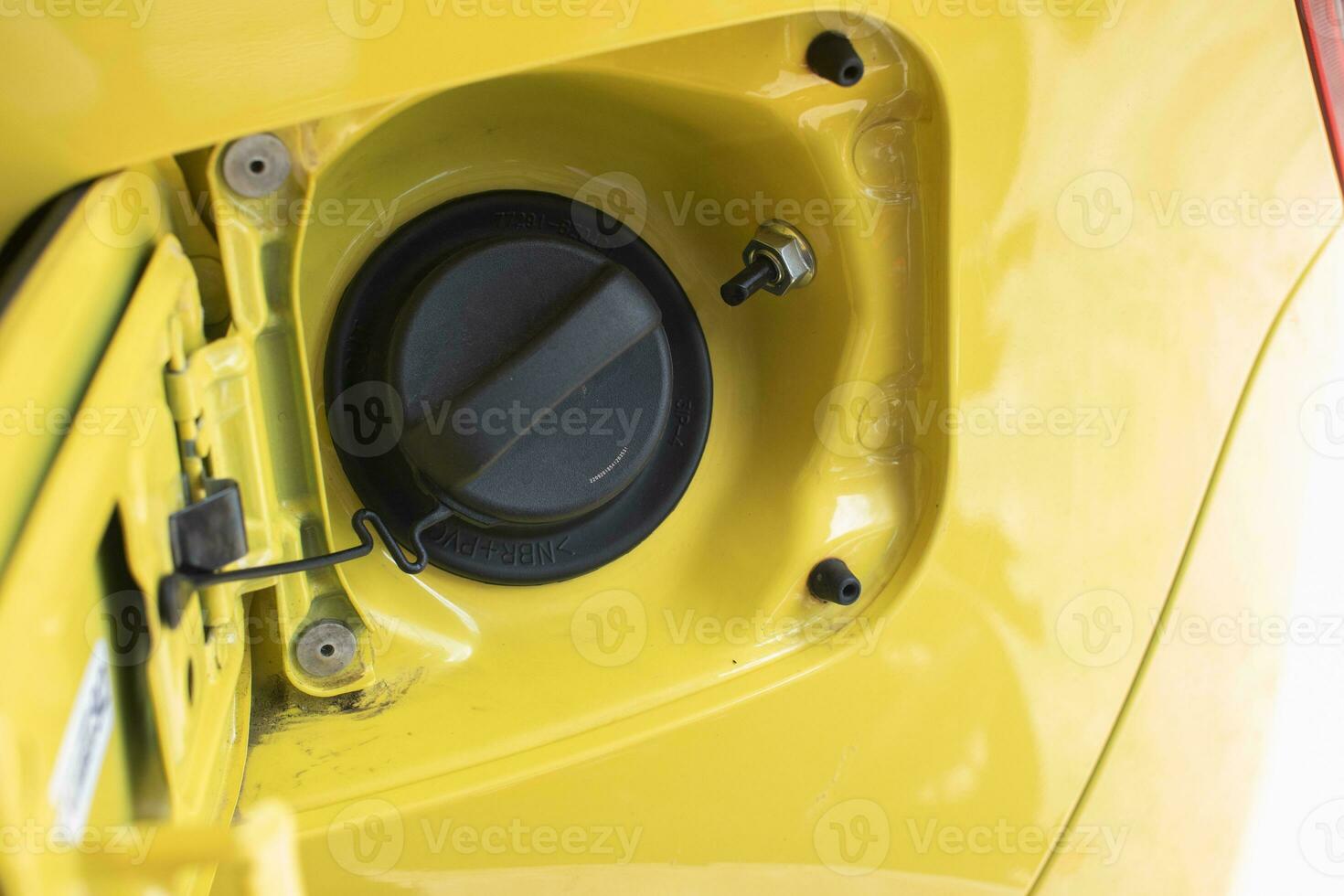 selective focus on the yellow car fuel tank cover with a warning using octane fuel number 92. soft focus photo