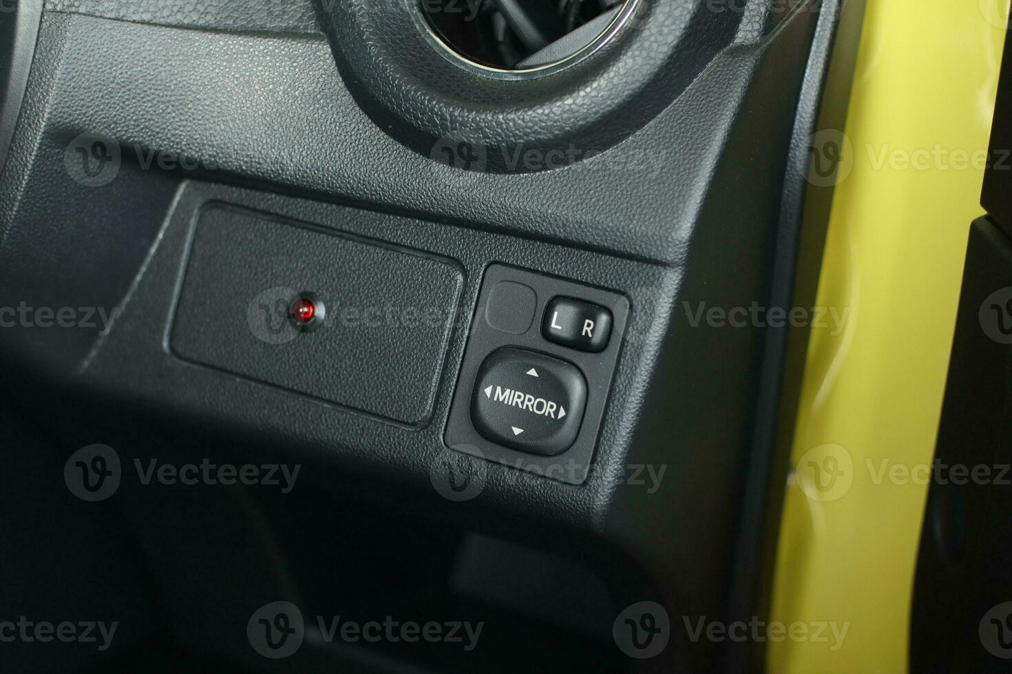 selective focus to the car rearview mirror direction control button. soft focus photo