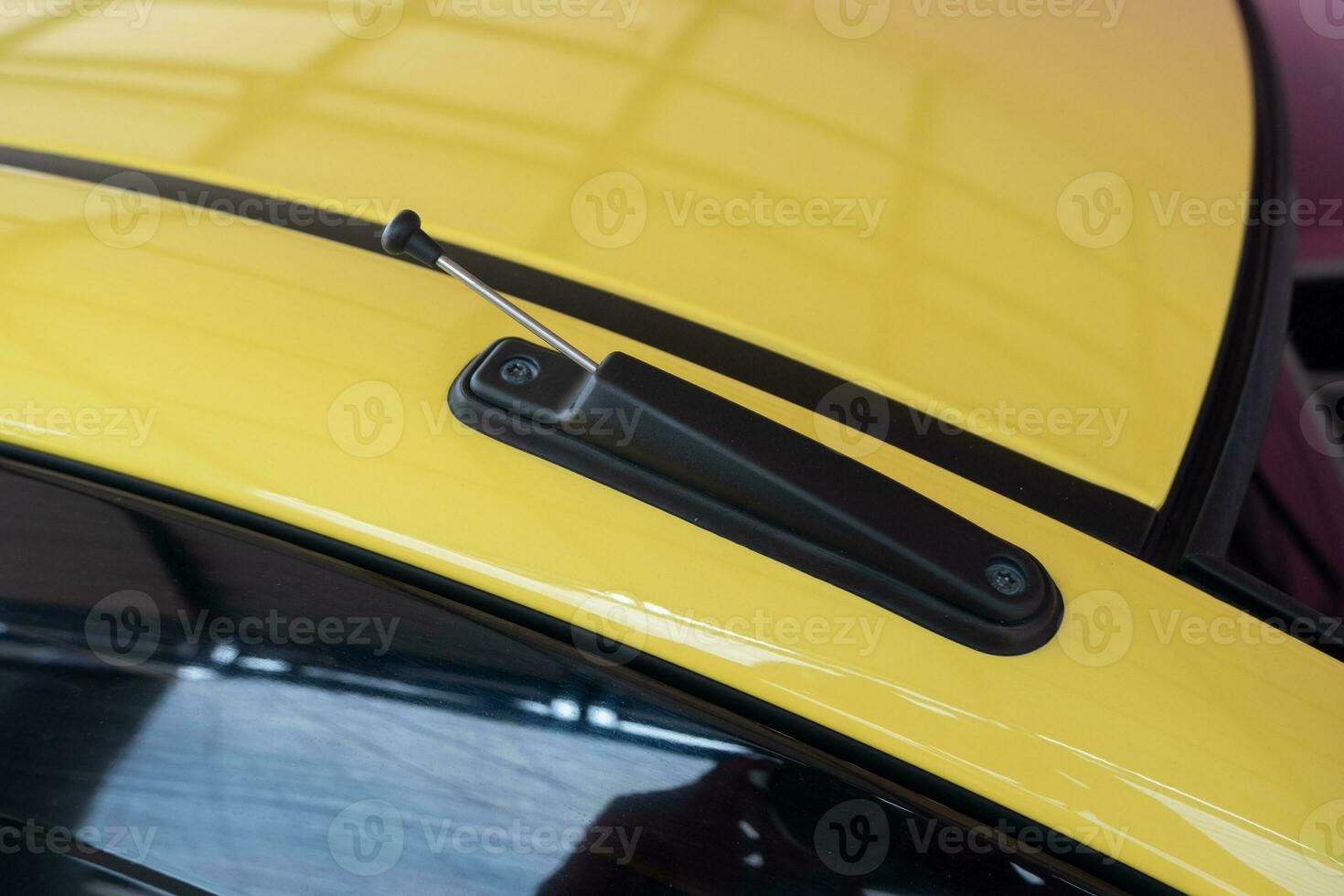 selectively focus onto the car radio antenna at the top of the car door. soft focus photo