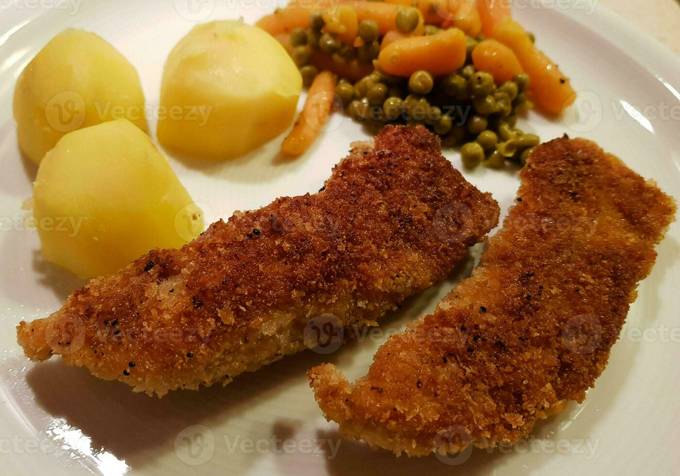 breaded wiener schnitzel with side dishes 24056137 Stock Photo at Vecteezy