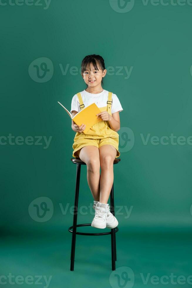 beautiful asian girl posing on blue background photo