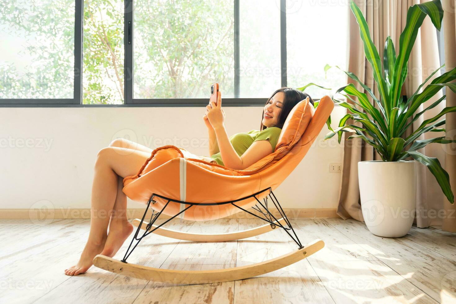 image of asian girl relaxing on a chair at her house photo