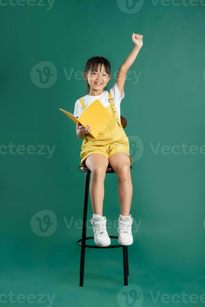 beautiful asian girl posing on blue background photo