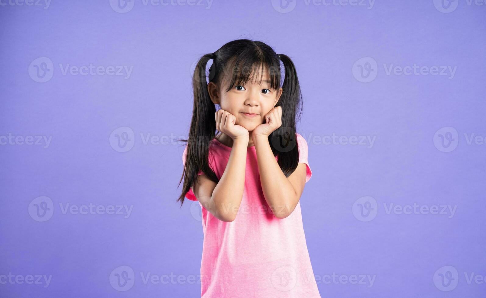 beautiful asian girl portrait posing on purple background photo