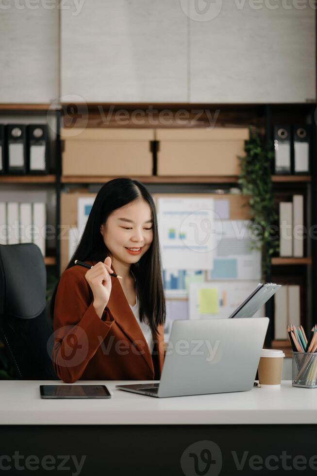 Business woman using tablet and laptop for doing math finance on an office desk, tax, report, accounting, statistics, and analytical research concept photo