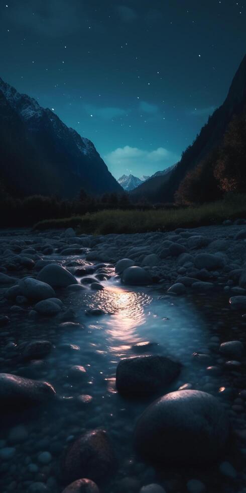 Nighttime Mountain Stream with Reflective Moon and Starlight on Glistening Stones photo