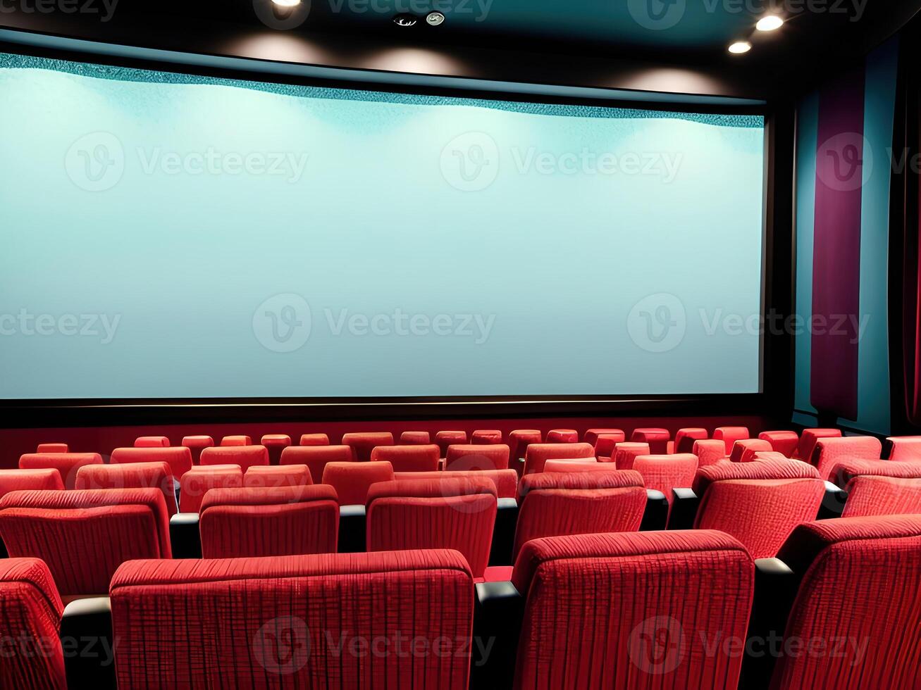 Cinema auditorium with red seats and large screen. photo