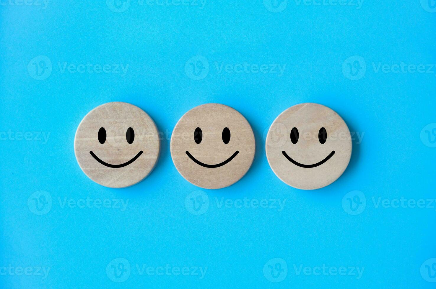 Happy emotion faces on wooden cubes. Customer satisfaction and evaluation concept. photo