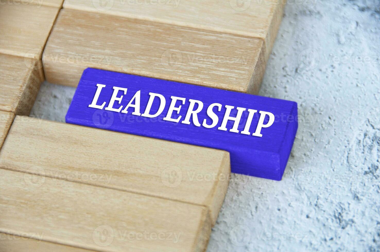 Leadership text on blue wooden block separated from the rest of the blocks. Leadership concept photo