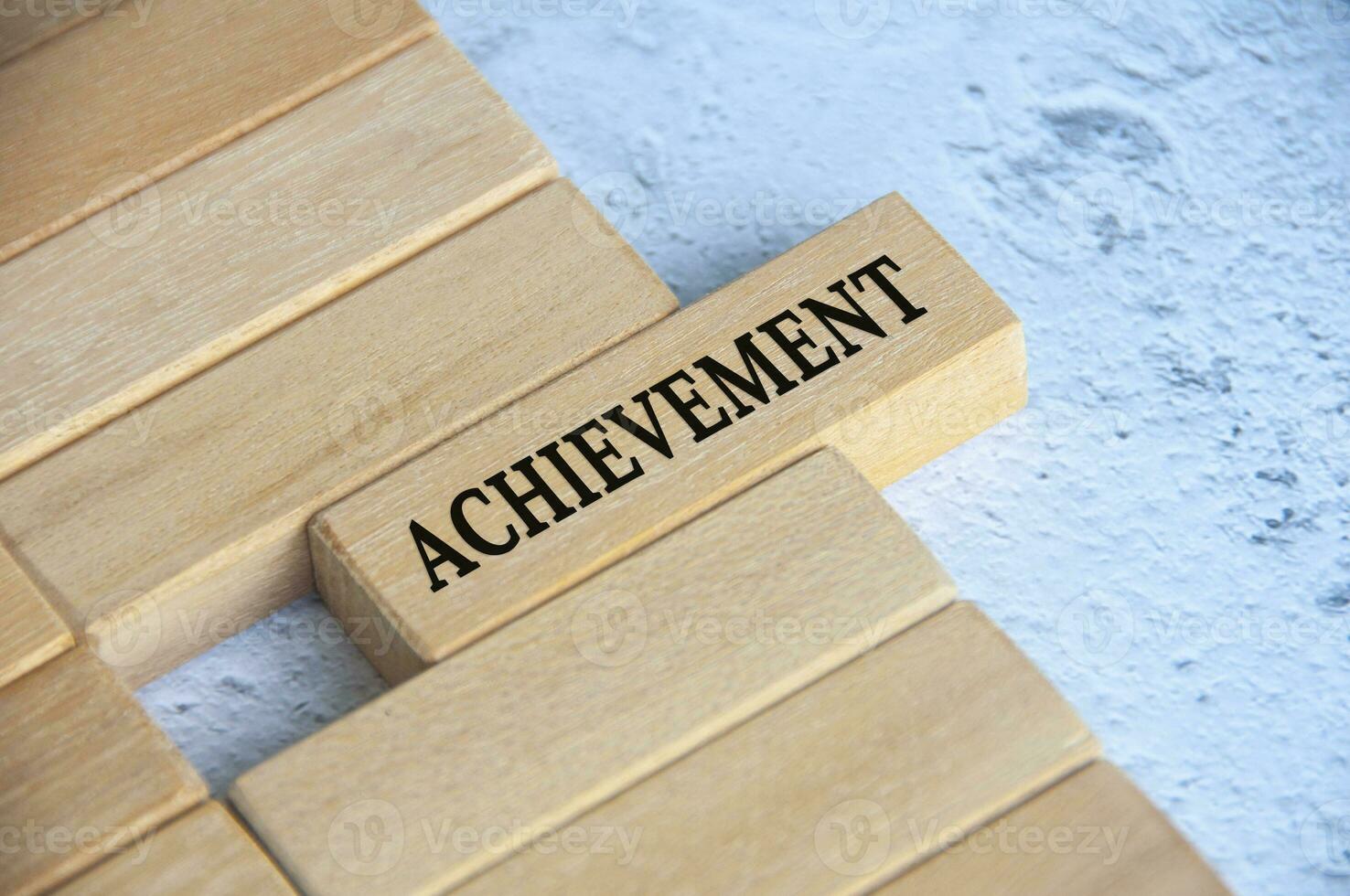 Top view of achievement text on wooden blocks. Business culture and goal achievement concept. photo