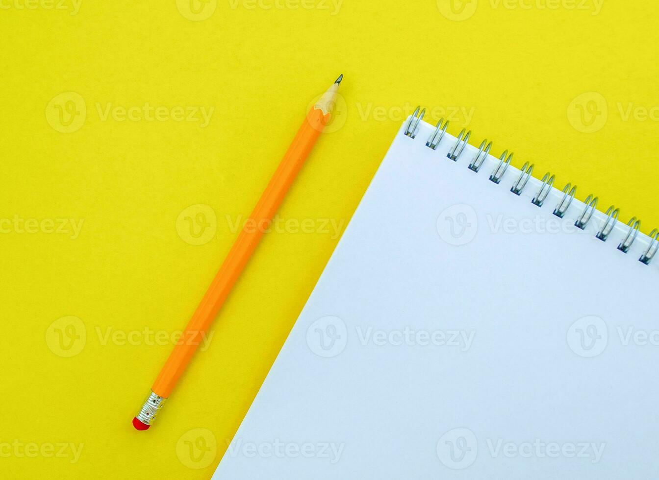White notebook with a spring and a pencil. photo
